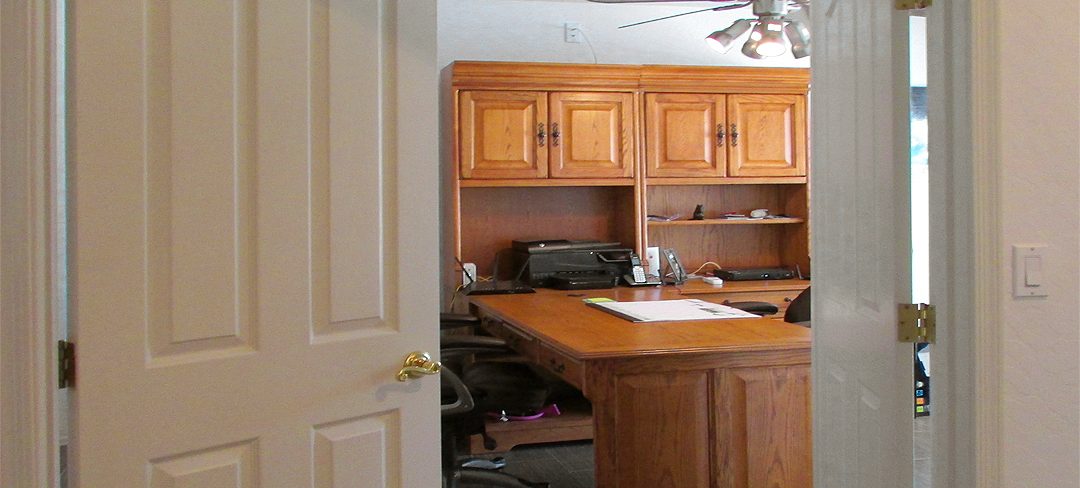 Wood desk and matching wood bookcase visible through partially open double doors - Bill Salvatore, Realty Excellence East Valley - Arizona Elite Properties 602-999-0952