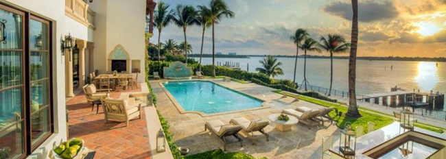 Pool, and ocean view back yard at sunset