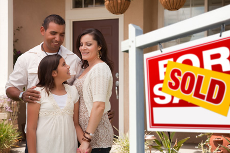 family standing beside SOLD sign in front of home - happy home sellers, happy home buyers, SOLD home - Bill Salvatore, Arizona Elite Properties 602-999-0952 - Arizona Real Estate