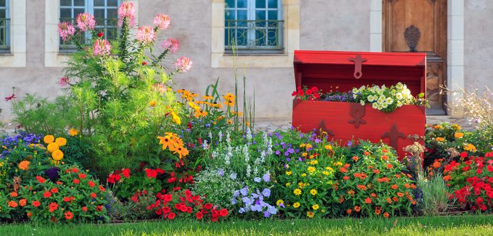 Vibrant flowers of all colors and lush green lawn in front of stone house - Getting your yard ready to put on the market, Selling your home, Listing your home - Bill Salvatore, Arizona Elite Properties 602-999-0952 - Tips for Home Sellers