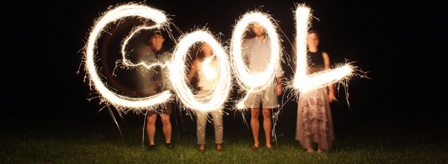 Four people standing in the dark making the letters COOL out of sparklers - Cool, Summer Heat, Weather - Bill Salvatore, Arizona Elite Properties