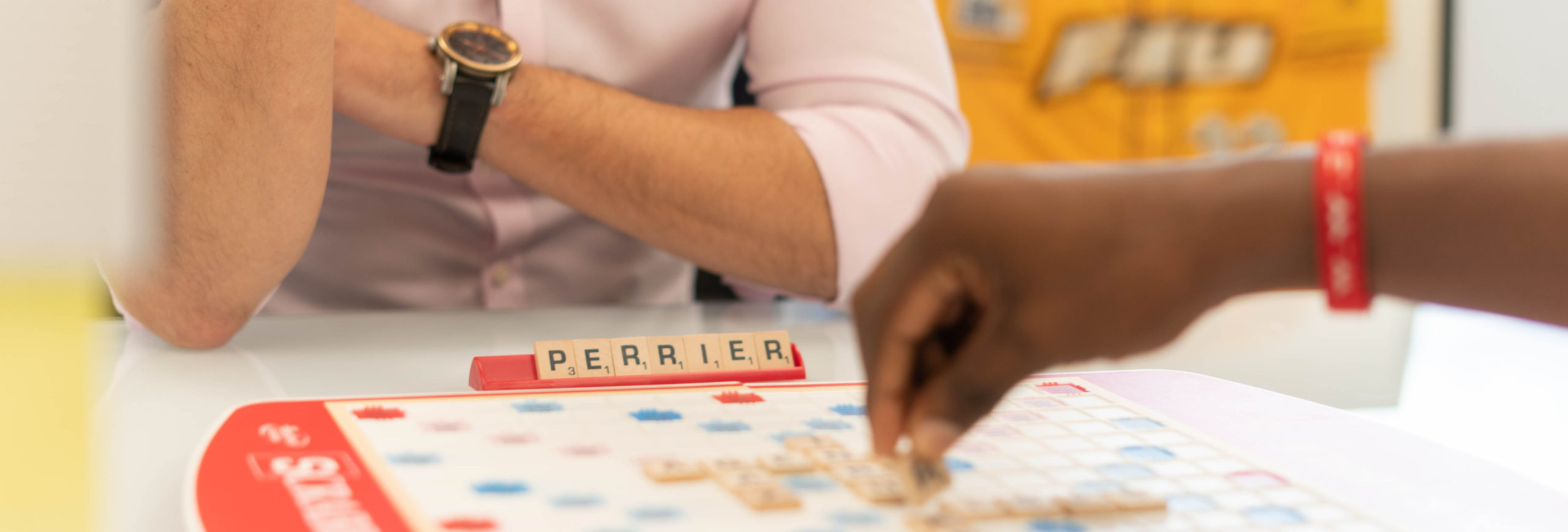 two people sitting at a table playing a word tile game - Game room, game night, john-benitez-_zNgspEPHCI-unsplash - Bill Salvatore, Your Valley Property Team - Arizona Elite Properties 602-999-0952