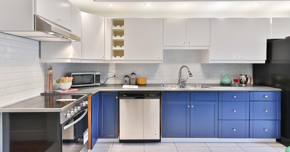 bright soffet lights over white top cabinets and medium blue bottom cabinets in kitchen - updated, modern, contemporary kitchen - sidekix-media--unsplash - Bill Salvatore, Your Valley Property Team - Arizona Elite Properties 602-999-0952