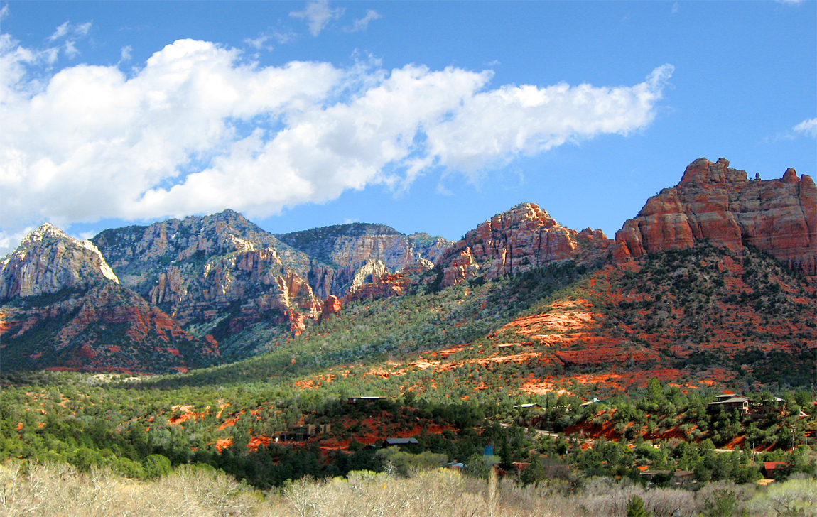 beautiful red rocks of Sedona backed by rocky, rugged mountains