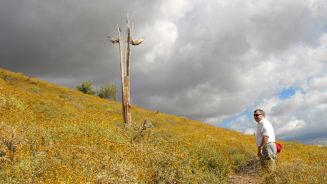 storm clouds over desert mountain and lone hiker