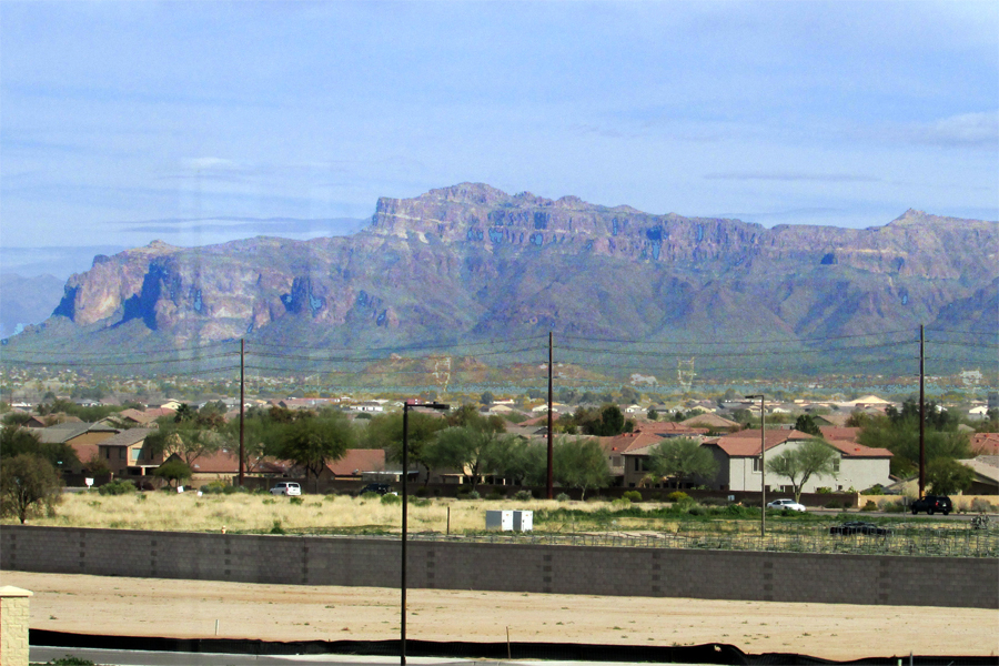 view of mountain range across a highway and roofs of homes - San Tan Mountain View - 1758 W Vineyard Plains Dr, Queen Creek AZ 85014 - Bill Salvatore, Your Valley Property Team - Arizona Elite Properties 602-999-0952